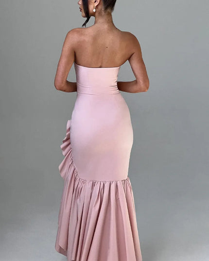 Back view of blush pink strapless maxi dress with ruffled slit