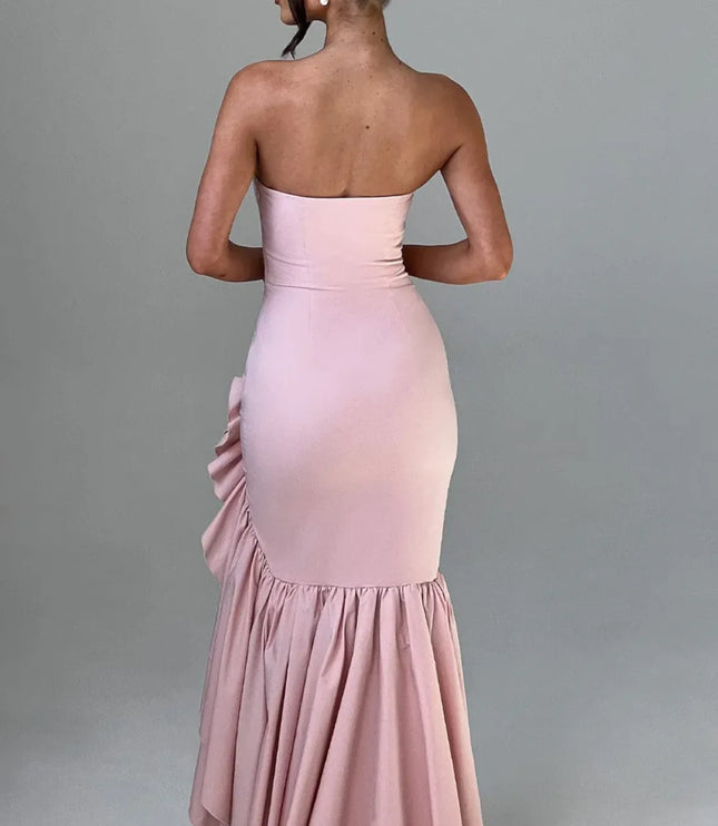 Back view of blush pink strapless maxi dress with ruffled slit