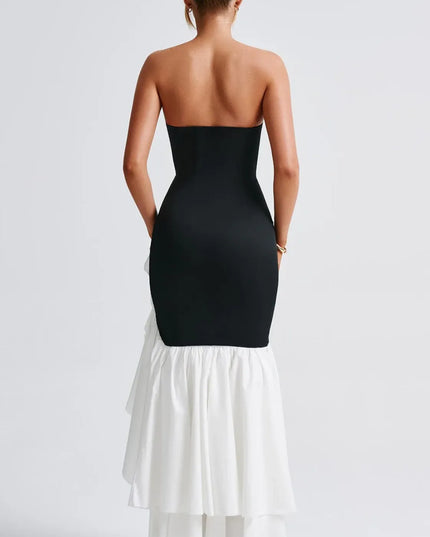 Back view of black and white strapless maxi dress with ruffled slit