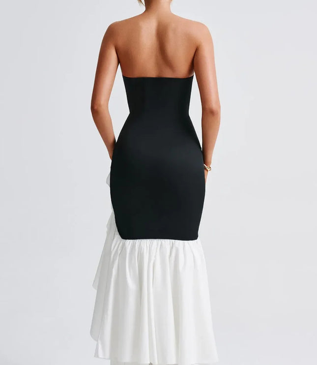 Back view of black and white strapless maxi dress with ruffled slit