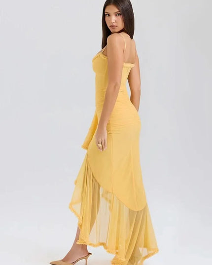 Back side view of yellow sweetheart maxi dress with ruffle trim and flowing sheer hem