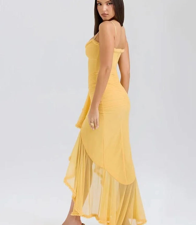 Back side view of yellow sweetheart maxi dress with ruffle trim and flowing sheer hem