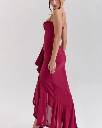 Side view of fuchsia ruffled sweetheart maxi dress with ruched skirt and flowing hem