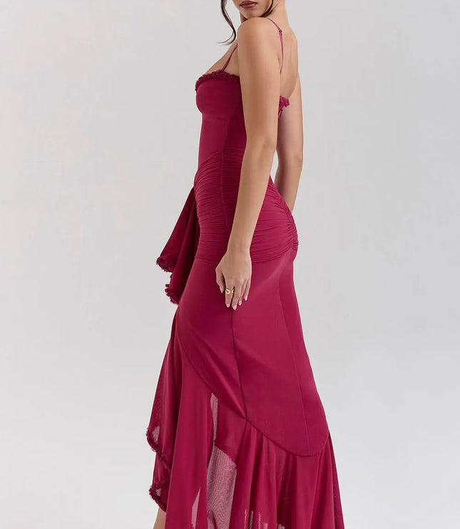 Side view of fuchsia ruffled sweetheart maxi dress with ruched skirt and flowing hem