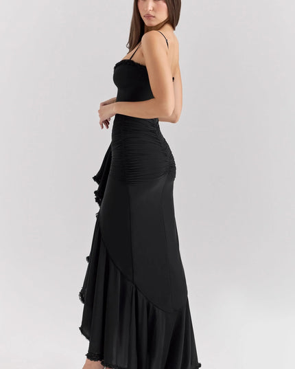 Side view of black ruffled sweetheart maxi dress with fitted silhouette and floor-length hem