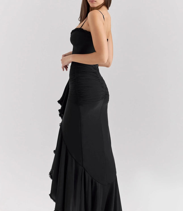 Side view of black ruffled sweetheart maxi dress with fitted silhouette and floor-length hem