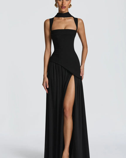 Front view of black maxi formal dress with high slit and asymmetrical overlay