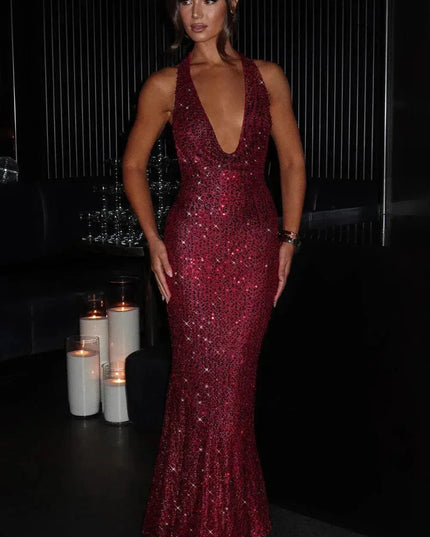 Burgundy sequin halter maxi dress with deep V-neckline and floor-length fit