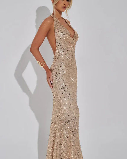 Champagne sequin halter maxi dress side profile with flowing skirt