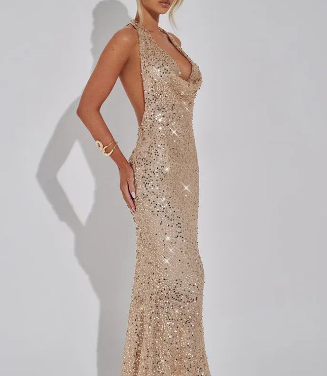 Champagne sequin halter maxi dress side profile with flowing skirt