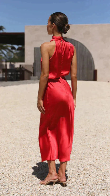 Red sleeveless halter midi dress with open back, worn from behind