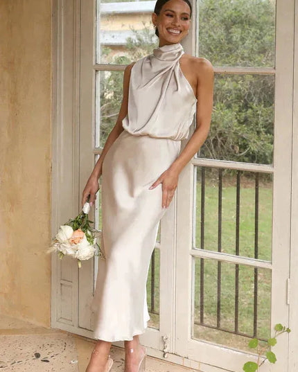 Cream halter midi dress with twisted neckline and flowing skirt