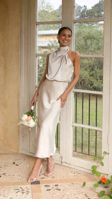Cream halter midi dress with twisted neckline and flowing skirt