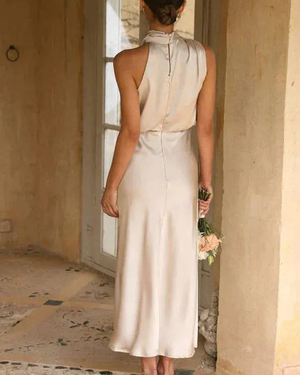 Back view of cream sleeveless halter dress with button closure