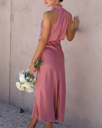 Back view of dusty rose halter dress with open back design