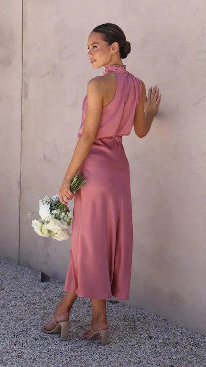 Back view of dusty rose halter dress with open back design
