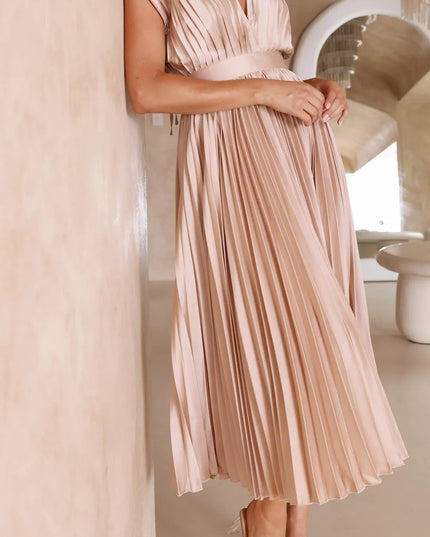 Back view blush pink sleeveless midi dress with pleated bodice and flowing skirt
