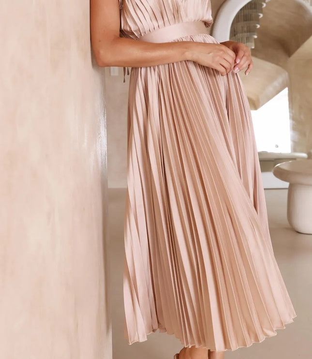Back view blush pink sleeveless midi dress with pleated bodice and flowing skirt