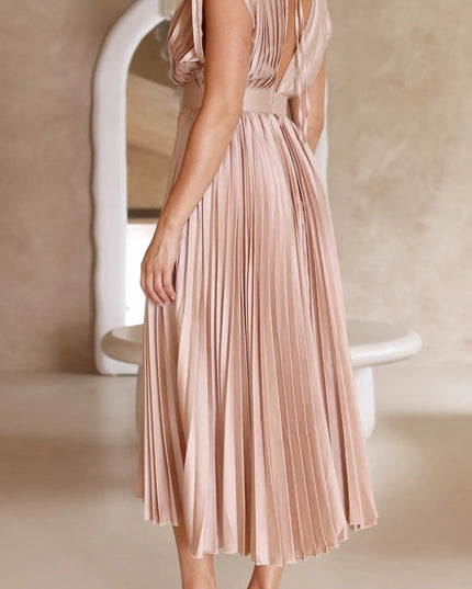 Back view of blush pink pleated midi dress showing open back detail