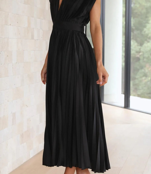 Side profile of black pleated midi dress showing high waist definition