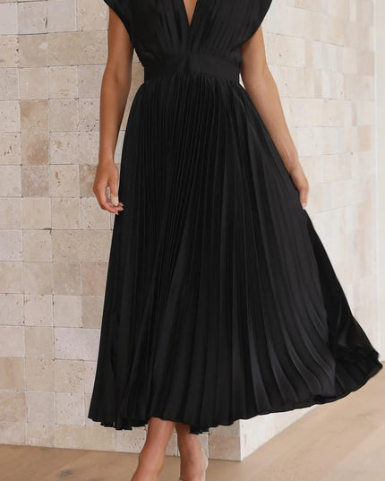 Back view of black pleated midi dress with tie closure detail
