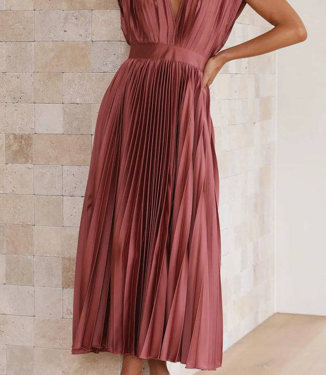 Side view of mauve pleated midi dress showing v-neckline and flowing skirt