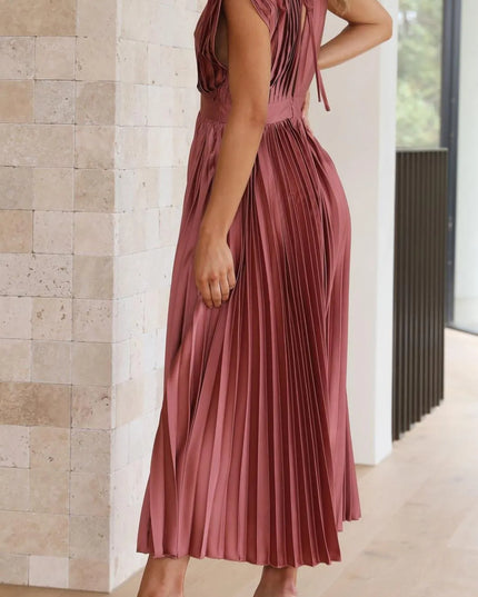 Back view of mauve sleeveless midi dress with open back detail and pleated skirt