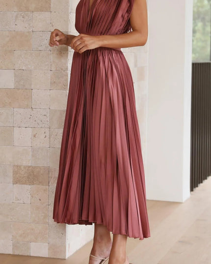 Three-quarter view mauve pleated midi dress showing v-neckline and high waist