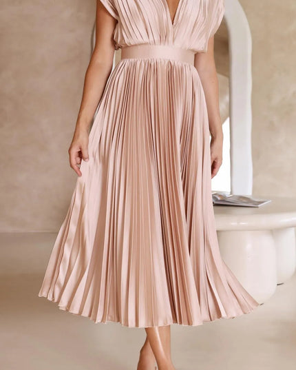 Front view blush pink pleated midi dress with deep v-neckline and cinched waist