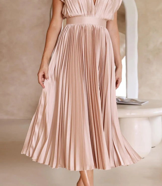 Front view blush pink pleated midi dress with deep v-neckline and cinched waist