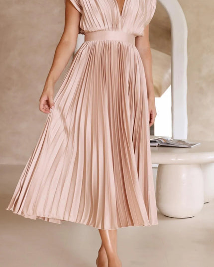 Side profile blush pink high waisted midi dress showing pleated skirt flow
