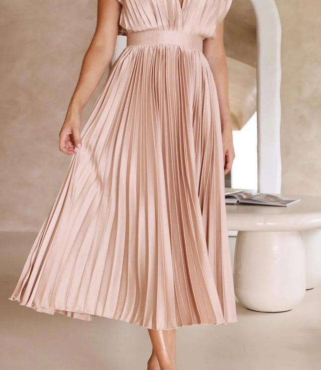 Side profile blush pink high waisted midi dress showing pleated skirt flow