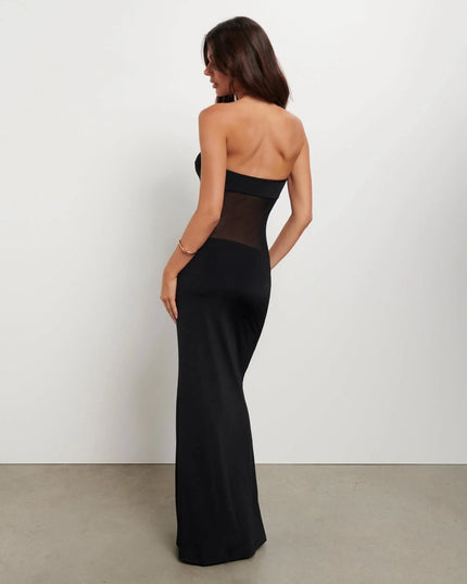 Back side view of black strapless maxi dress featuring sheer midriff panel and fitted skirt
