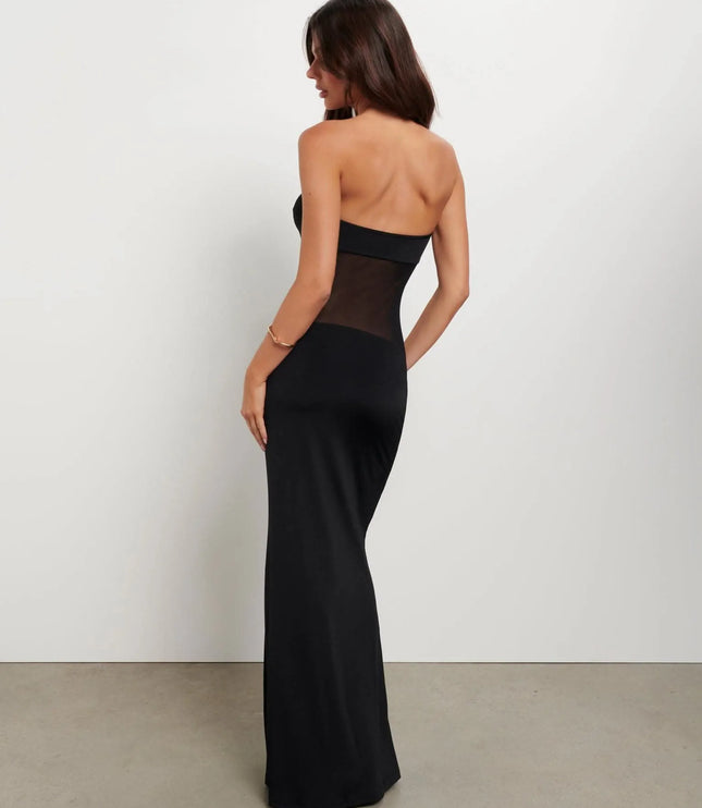 Back side view of black strapless maxi dress featuring sheer midriff panel and fitted skirt