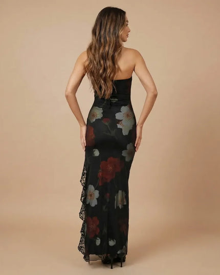 Back view of black strapless printed maxi dress with floral print and lace side detail
