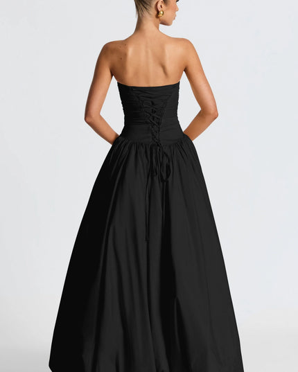 Back view of black strapless ruched maxi dress with lace-up corset back