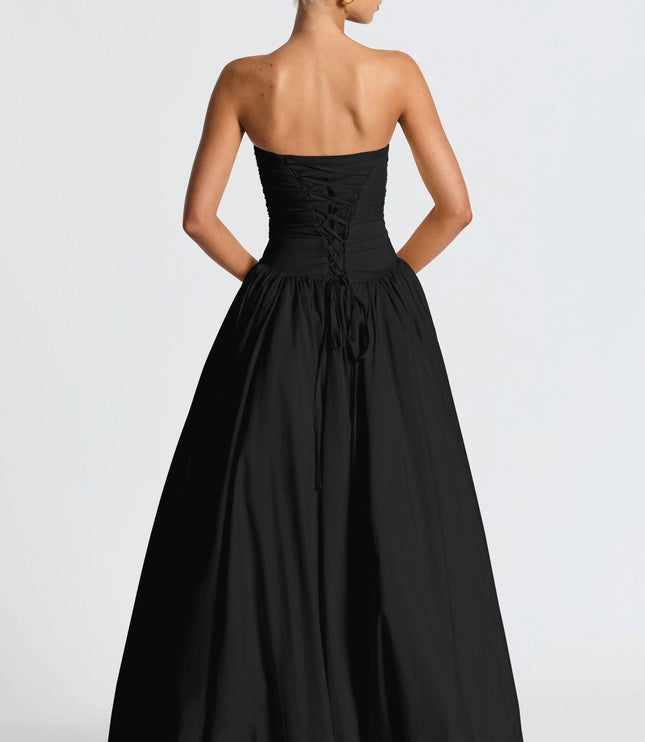 Back view of black strapless ruched maxi dress with lace-up corset back