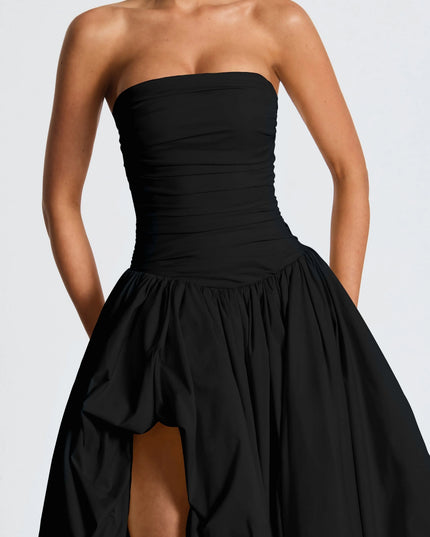 Close-up of black strapless ruched bodice with high-low maxi skirt