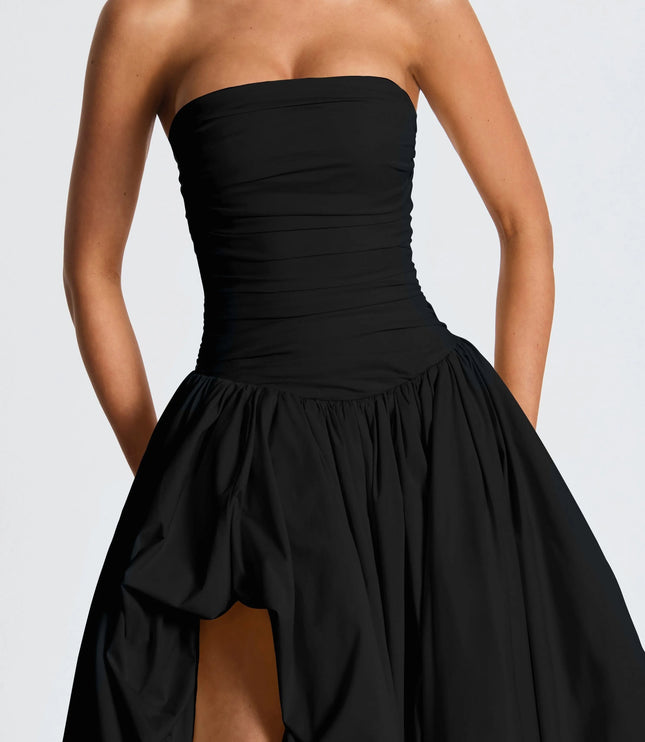 Close-up of black strapless ruched bodice with high-low maxi skirt