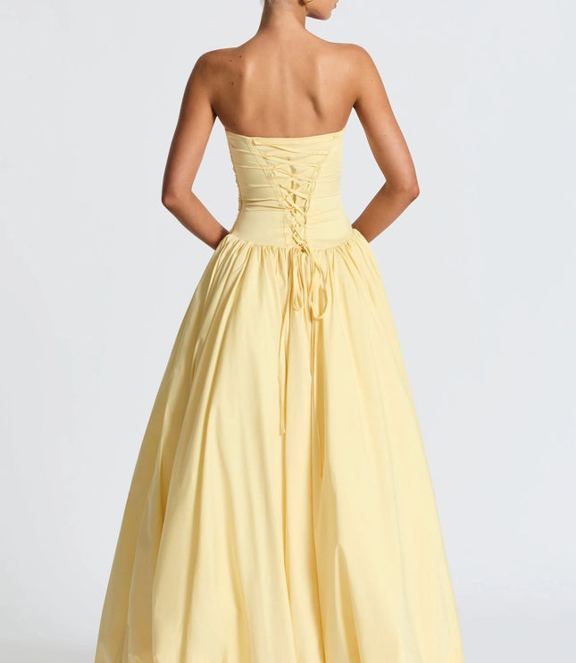Back view of yellow strapless dress showing lace-up corset detail