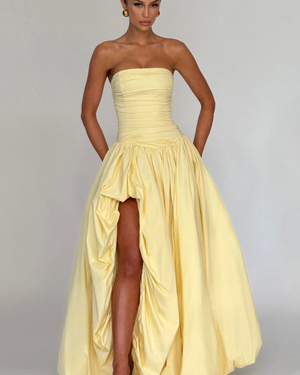 Full-length yellow strapless dress with ruched detailing and high-low hem