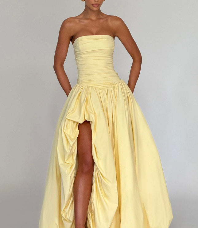 Full-length yellow strapless dress with ruched detailing and high-low hem
