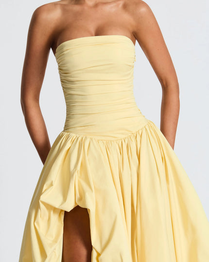 Close-up of yellow strapless dress bodice with horizontal ruching detail