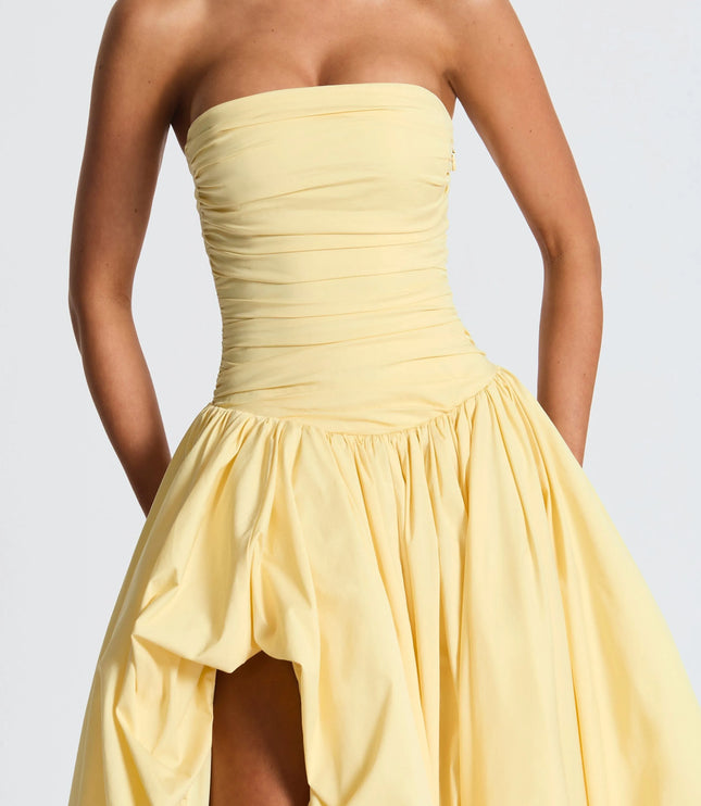 Close-up of yellow strapless dress bodice with horizontal ruching detail