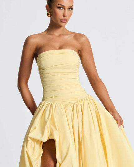 Yellow strapless maxi dress with ruched waist and voluminous high-low skirt