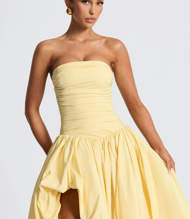 Yellow strapless maxi dress with ruched waist and voluminous high-low skirt