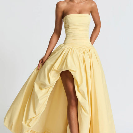 Strapless yellow high-low maxi dress with ruched bodice and flowing skirt
