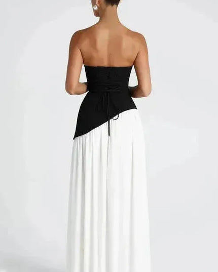 Back view of black and white strapless maxi dress with high slit and open back