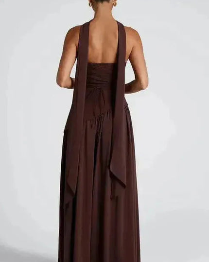 Back view of burgundy strapless maxi dress showing open back and flowing high slit