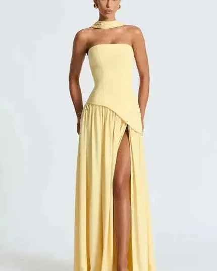 Pale yellow strapless maxi dress with asymmetrical high slit and draped skirt